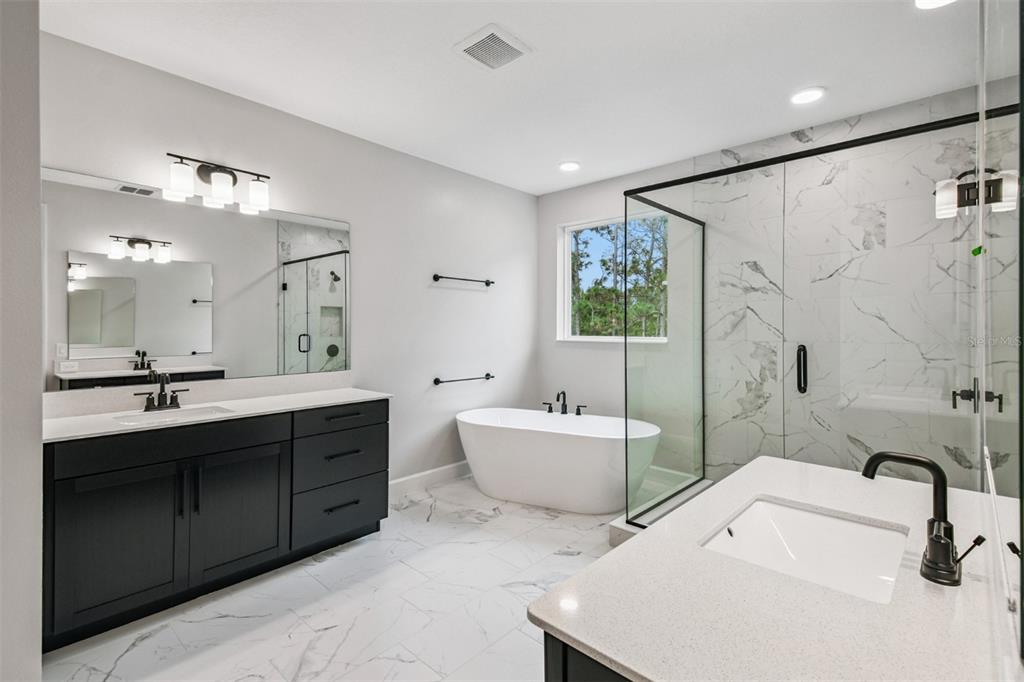 5262 Prairie Preserve Run St. Cloud, FL 34772 - Photo 15 of 40 a bathroom with a tub sink mirror and a shower