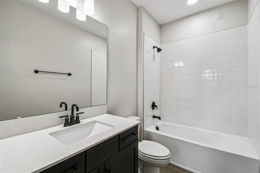 5262 Prairie Preserve Run St. Cloud, FL 34772 - Photo 20 of 40 a bathroom with a sink a toilet and shower