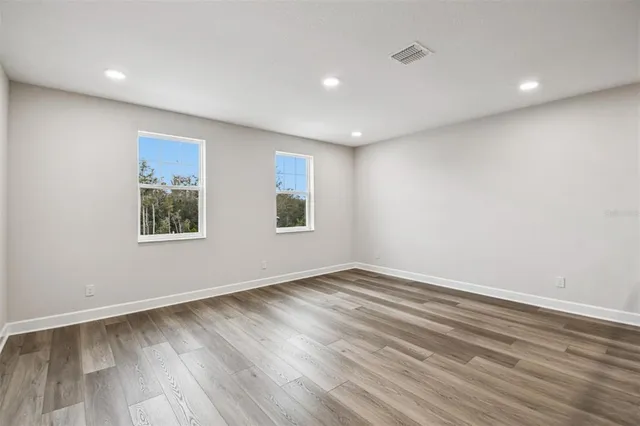 a view of hallway with wooden floor