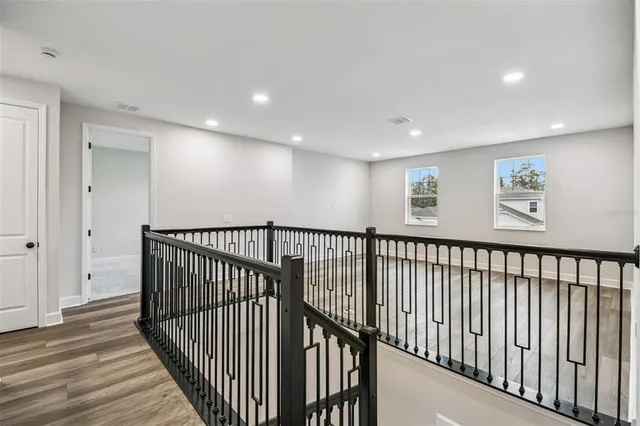 a view of entryway with wooden floor and stairs
