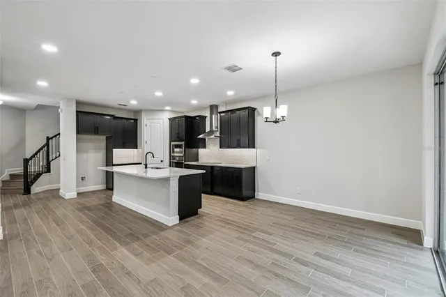 a large kitchen with a lot of cabinets and refrigerator