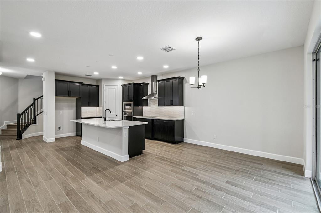 5262 Prairie Preserve Run St. Cloud, FL 34772 - Photo 3 of 40 a large kitchen with a lot of cabinets and refrigerator