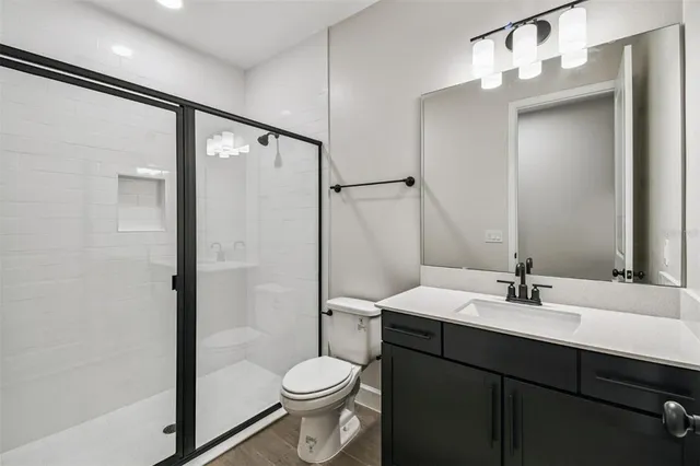 a view of kitchen with white cabinets and refrigerator