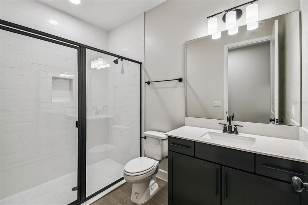 5262 Prairie Preserve Run St. Cloud, FL 34772 - Photo 31 of 40 a bathroom with a sink toilet and shower