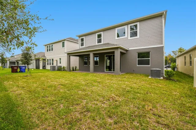 a front view of a house with a garden and garage