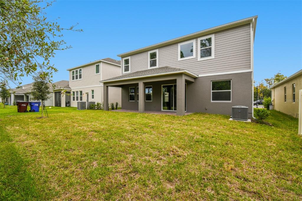 5262 Prairie Preserve Run St. Cloud, FL 34772 - Photo 35 of 40 a front view of a house with a garden