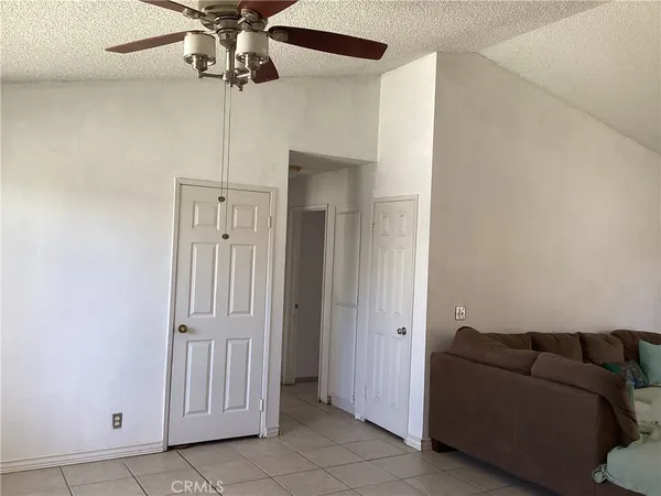 a living room with furniture and a ceiling fan