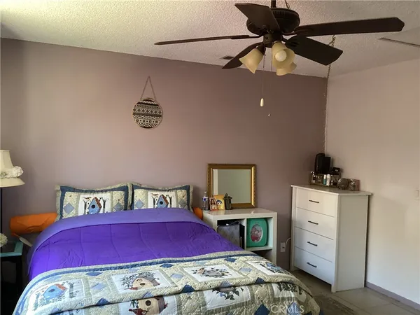 a bedroom with furniture and a dresser