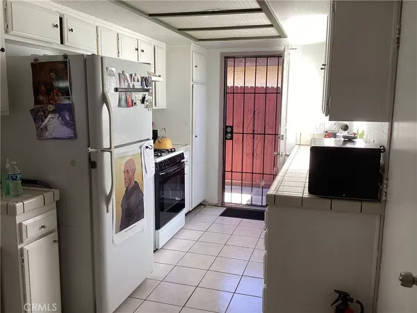 a kitchen with stainless steel appliances a refrigerator a stove a microwave and cabinets