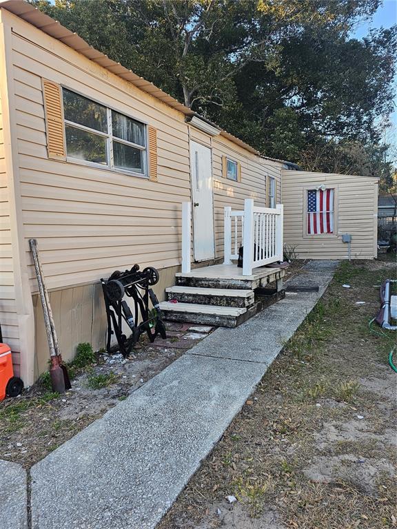 a backyard of a house with barbeque oven and table