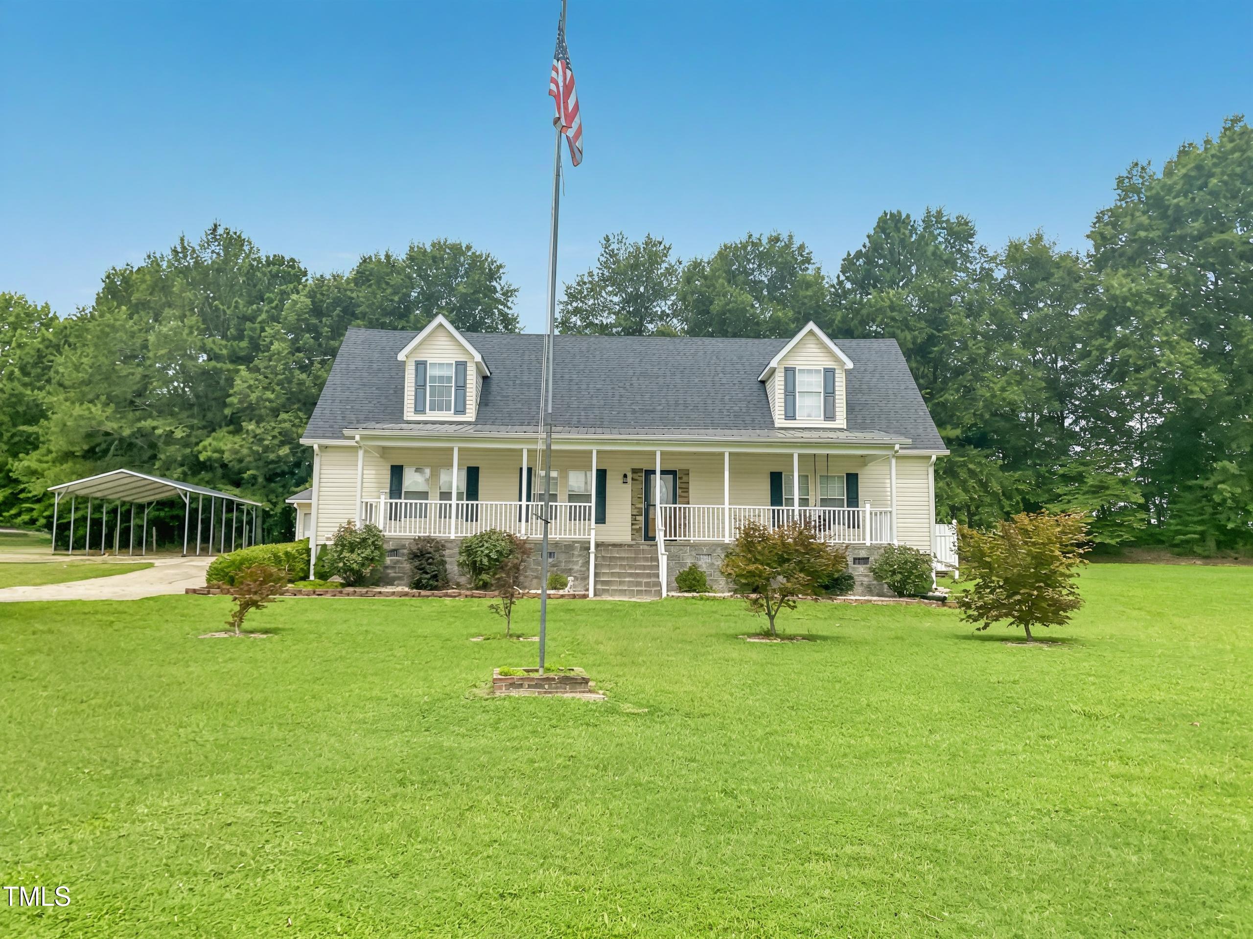 a front view of a house with a yard table and chairs