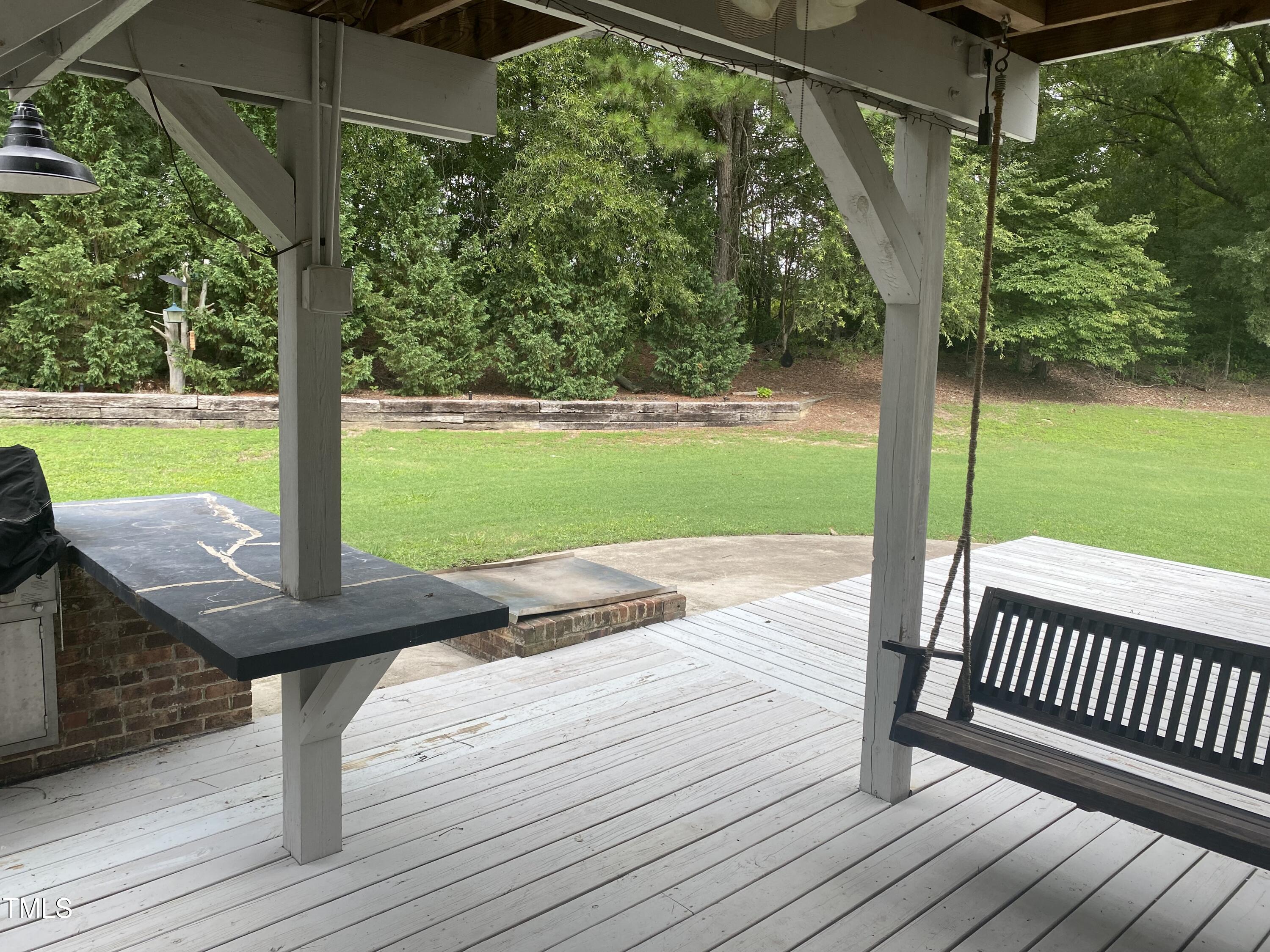 920 Vanco Mill Road Henderson, NC 27537 - Photo 23 of 26 a view of a wooden deck with a yard