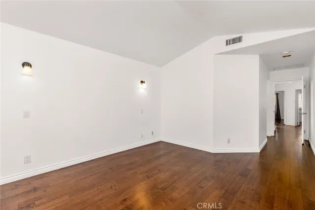 a view of a room with wooden floor