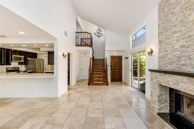 a view of a livingroom with furniture and an empty room