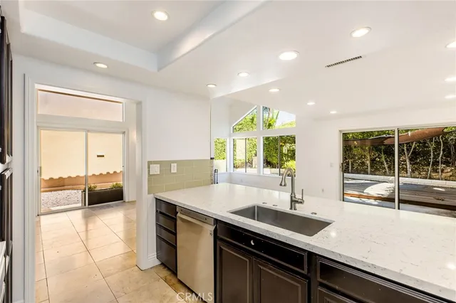 a kitchen with a sink and large window