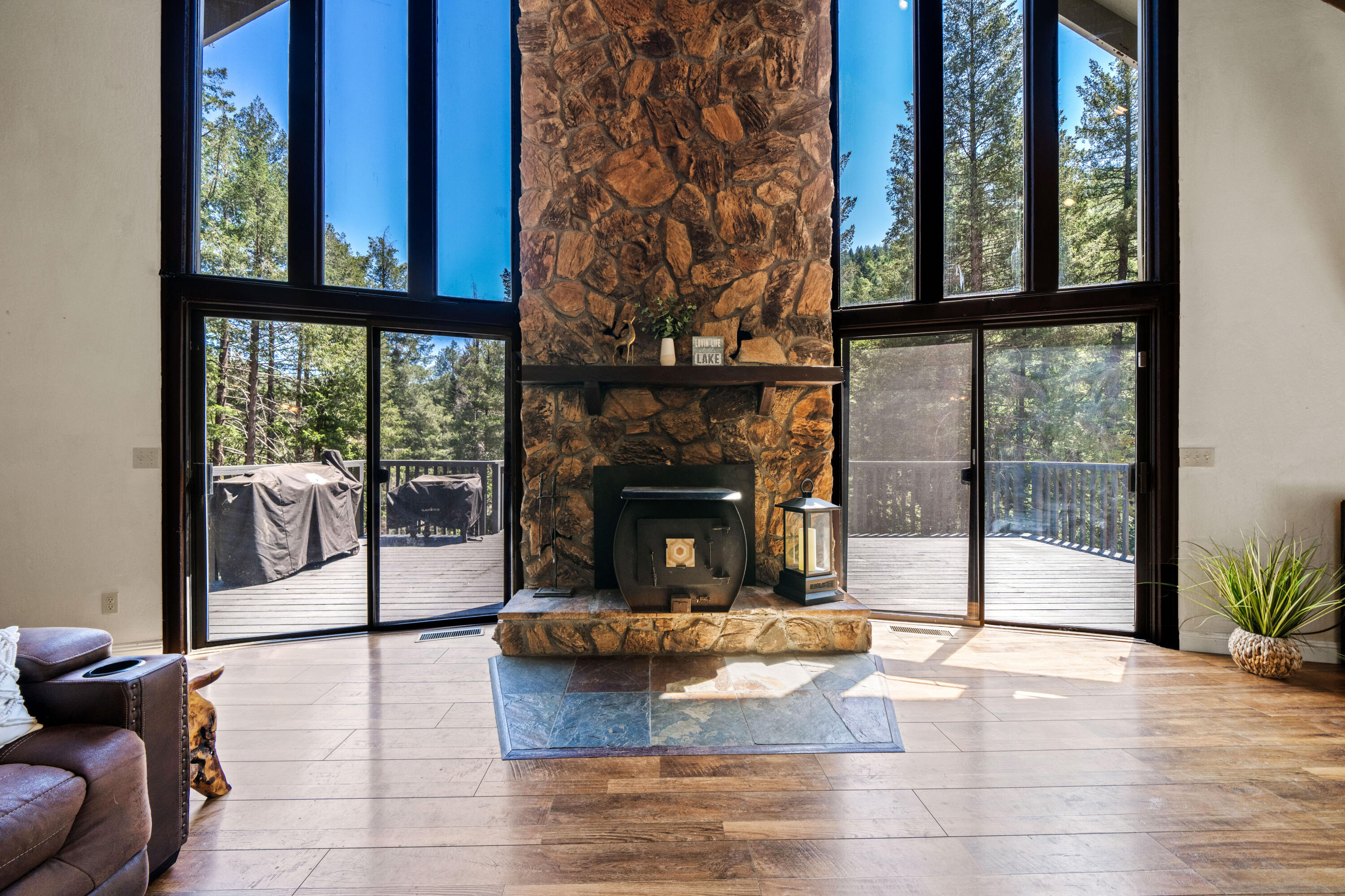 19610 Roaring Brook Way Lakehead, CA 96051 - Photo 12 of 58 a living room with a fireplace and a floor to ceiling window