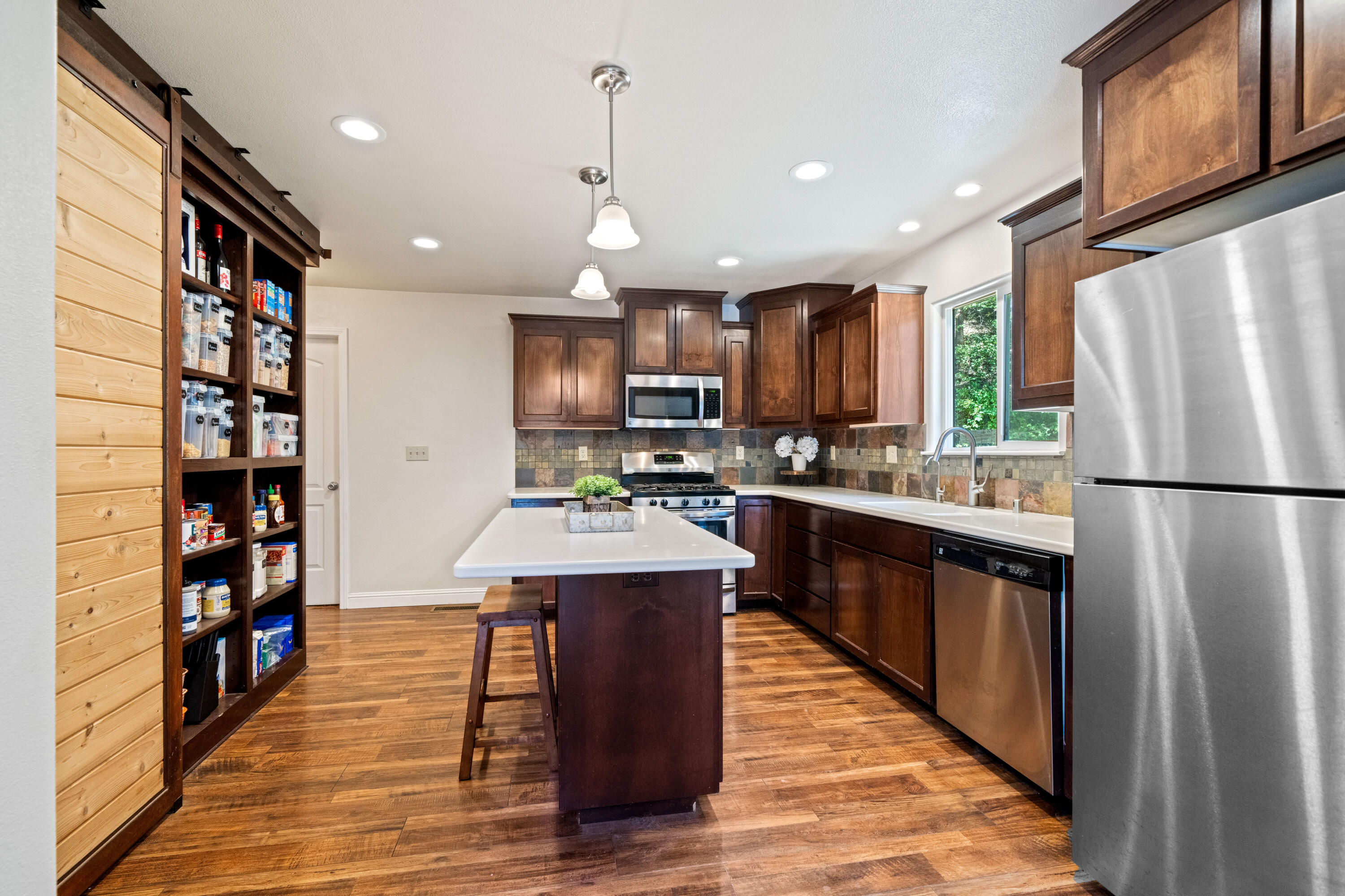 19610 Roaring Brook Way Lakehead, CA 96051 - Photo 19 of 58 a kitchen with stainless steel appliances granite countertop a refrigerator a stove top oven a sink and a refrigerator