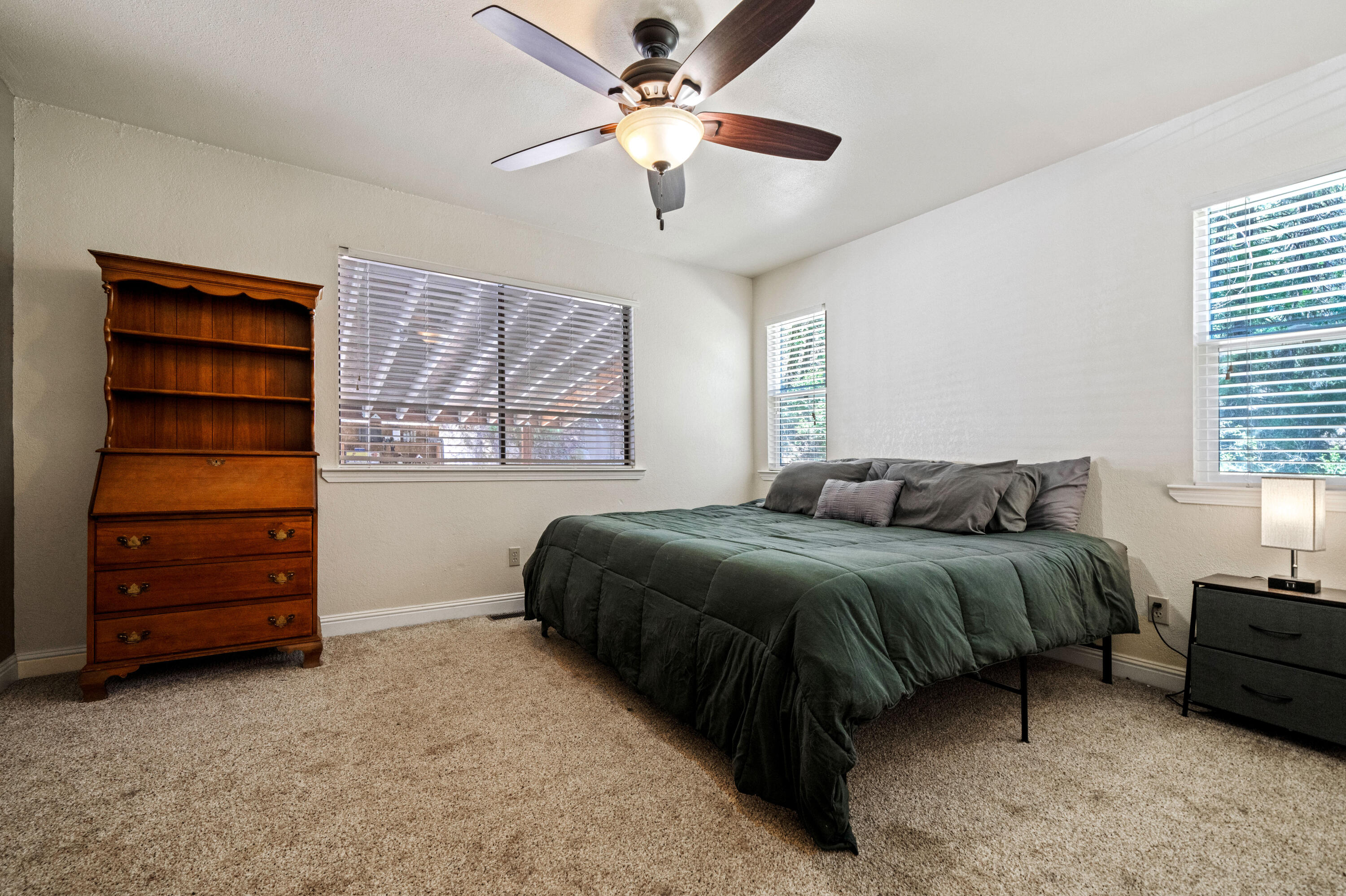 19610 Roaring Brook Way Lakehead, CA 96051 - Photo 26 of 58 a spacious bedroom with a bed and a ceiling fan
