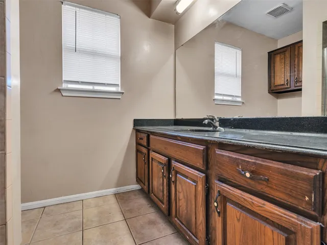 a kitchen with granite countertop a sink and a stove