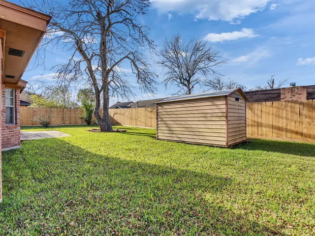 a view of a backyard with large trees