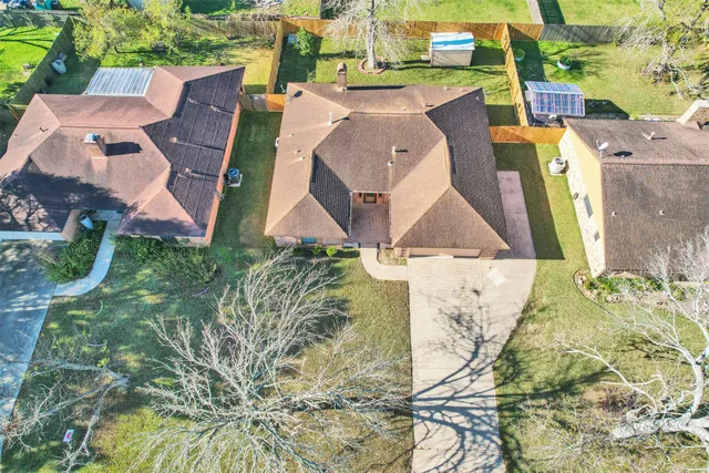 an aerial view of a house with a yard