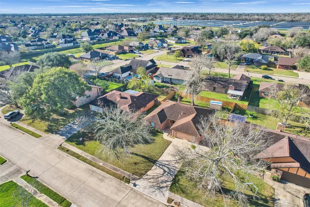 an aerial view of residential houses with outdoor space