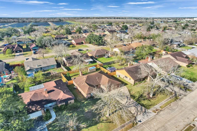 an aerial view of residential houses with outdoor space
