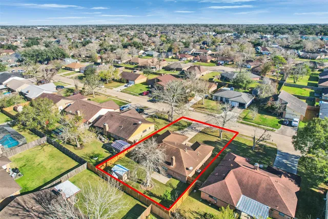 an aerial view of a residential houses with outdoor space and street view