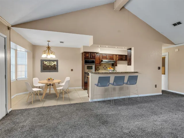 a living room with stainless steel appliances kitchen island granite countertop furniture and a kitchen view