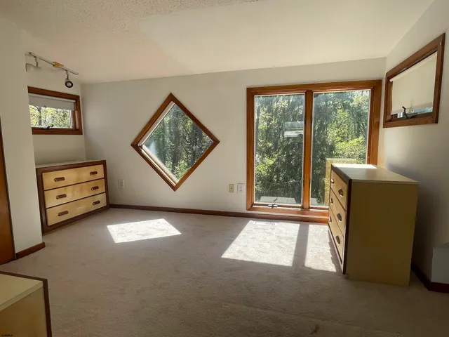 a view of a livingroom with furniture and a window