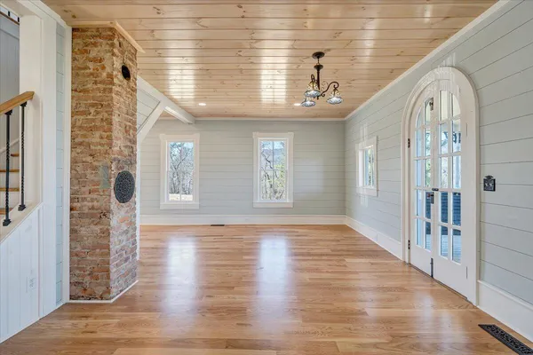 a large kitchen with stainless steel appliances granite countertop a lot of counter space and wooden floors