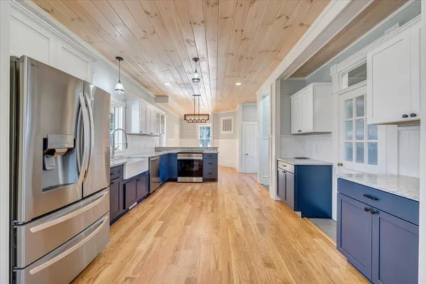 a view of a hallway with wooden floor