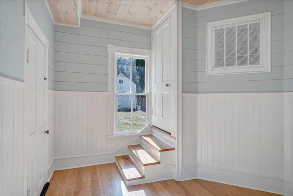a view of a hallway with wooden floor