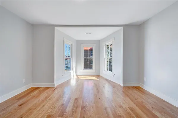 an aerial view of residential houses with outdoor space and trees