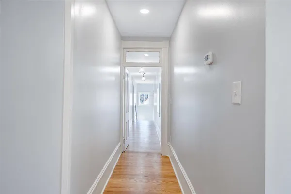 a view of a room with wooden floor and windows