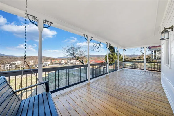 a view of an entryway with wooden floor and a livingroom