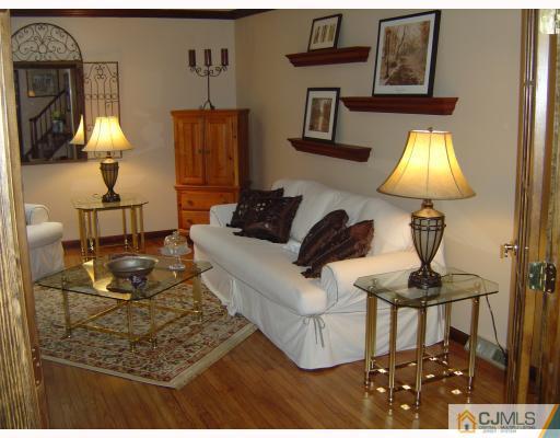 276 Hamlin Road North Brunswick, NJ 08902 - Photo 2 of 10 a living room with furniture and a lamp