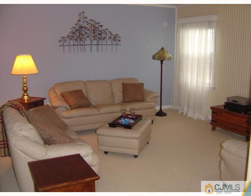 276 Hamlin Road North Brunswick, NJ 08902 - Photo 5 of 10 a living room with furniture and a lamp