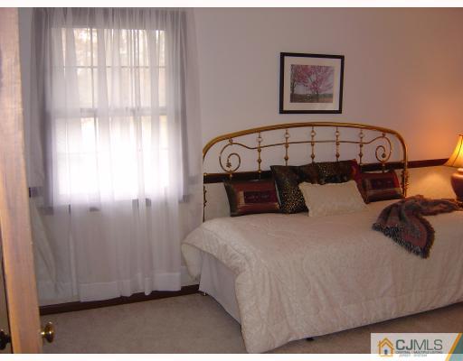 276 Hamlin Road North Brunswick, NJ 08902 - Photo 7 of 10 a bedroom with a bed and a window