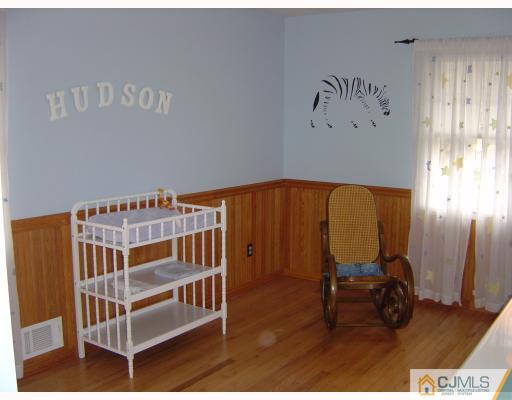 276 Hamlin Road North Brunswick, NJ 08902 - Photo 8 of 10 a view of a bedroom with baby crib and a furniture