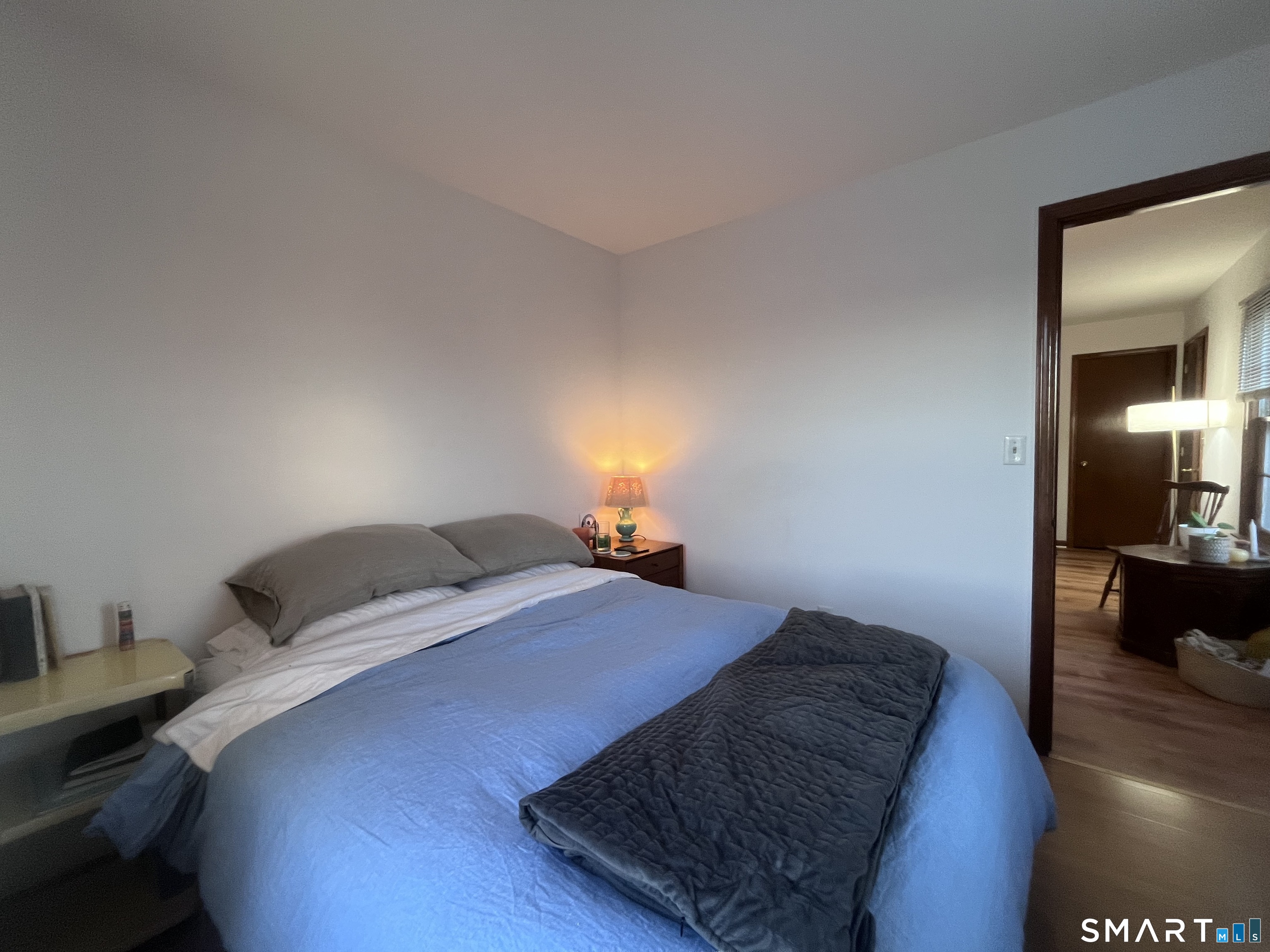 124 Thorpe Street Fairfield, CT 06824 - Photo 13 of 23 a bedroom with a bed and wooden floor