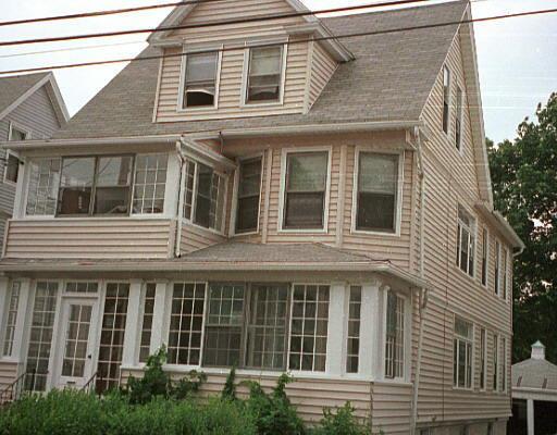 183 Hawley Avenue, Unit 1 Bridgeport, CT 06606 - Photo 1 of 1 a view of a brick building next to a yard