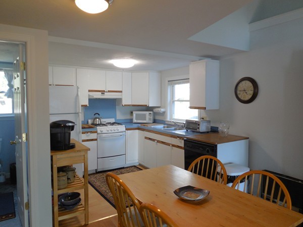 16 Leno Road Holland, MA 01521 - Photo 12 of 30 a kitchen with a table chairs a stove a sink and dishwasher