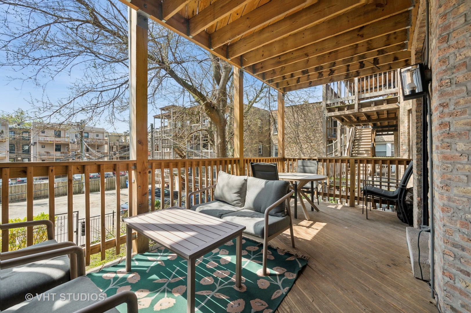845 West Grace Street, Unit 2W Chicago, IL 60613 - Photo 18 of 21 a balcony with furniture and wooden floor
