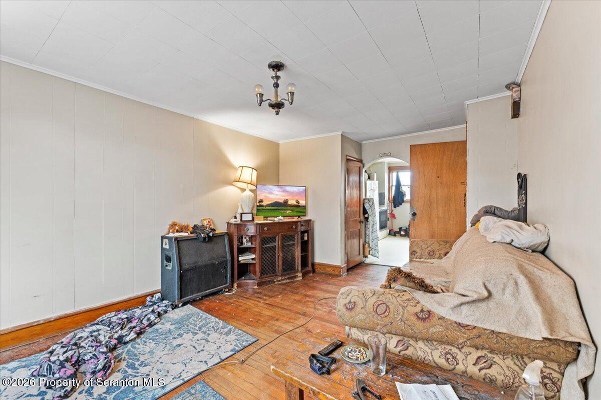 622 East Market Street Scranton, PA 18509 - Photo 12 of 44 a bed room with a bed and a chandelier