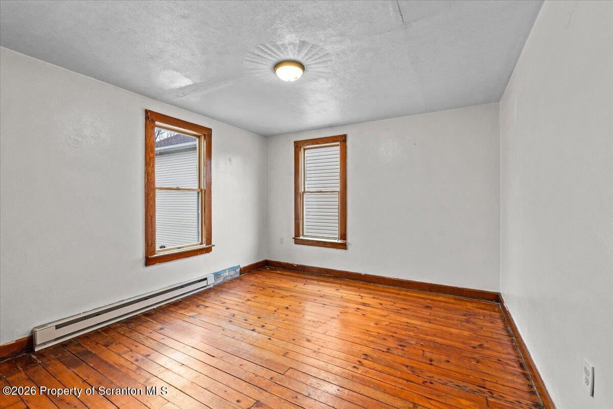 622 East Market Street Scranton, PA 18509 - Photo 22 of 44 an empty room with wooden floor and windows