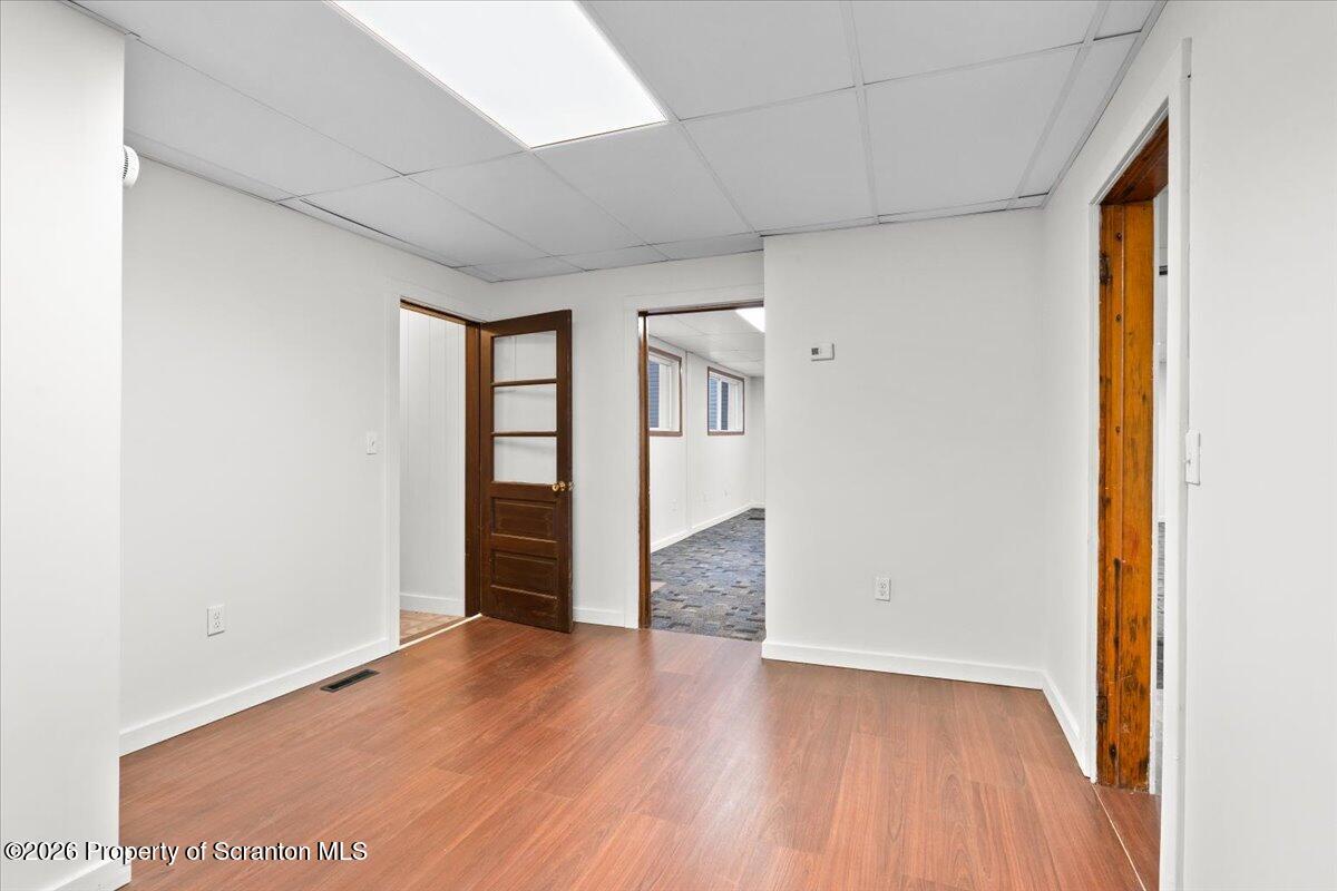 622 East Market Street Scranton, PA 18509 - Photo 39 of 44 an empty room with wooden floor and windows