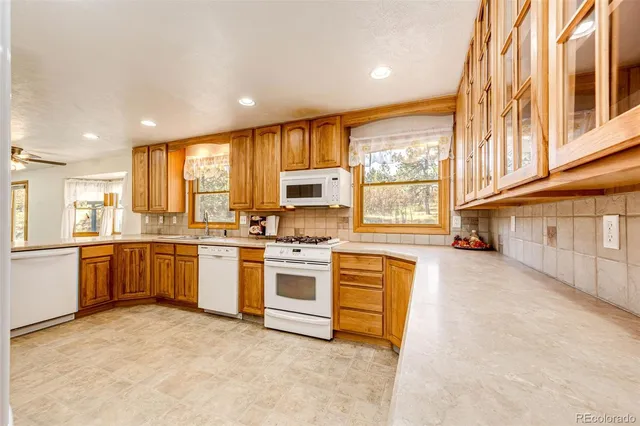 a kitchen with a stove a sink and a refrigerator