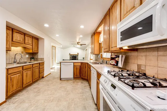 a large kitchen with stainless steel appliances a large window and a counter top space