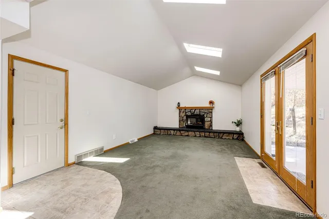 a view of kitchen with refrigerator and window